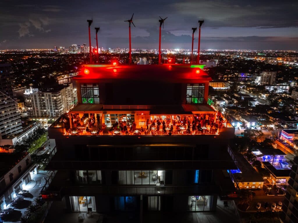 Guests gather under red Halloween lighting at Nubé Rooftop in Fort Lauderdale, an elevated evening of cocktails, music, and skyline views.